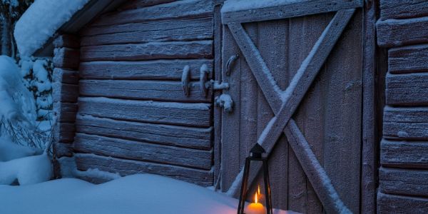 cold barn in morning with snow and candlelight