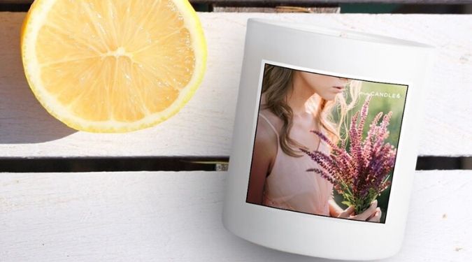 nycandle soy candle in white vessel with photo label by sliced lemon