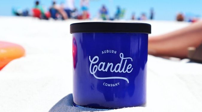 Auburn Candle Company blue candle vessel on beach