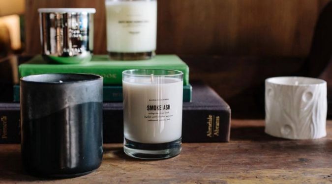 white soy candles on books baxter of california