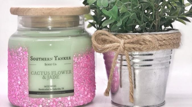 pink glitter candle jar with wooden lid near plant silver container southern yankee scent company