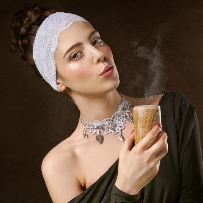 Cool woman holding candle blowing out wick