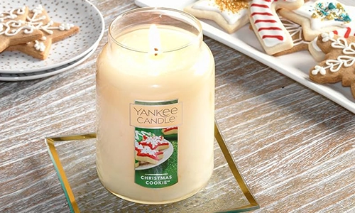 Yankee Candle Christmas Cookie large jar candle beside decorated holiday sugar cookies