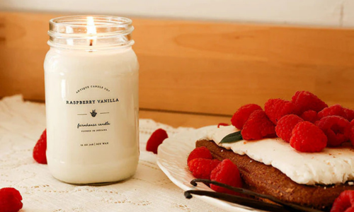 Antique Candle Co Raspberry Vanilla candle styled with fresh raspberries and vanilla beans