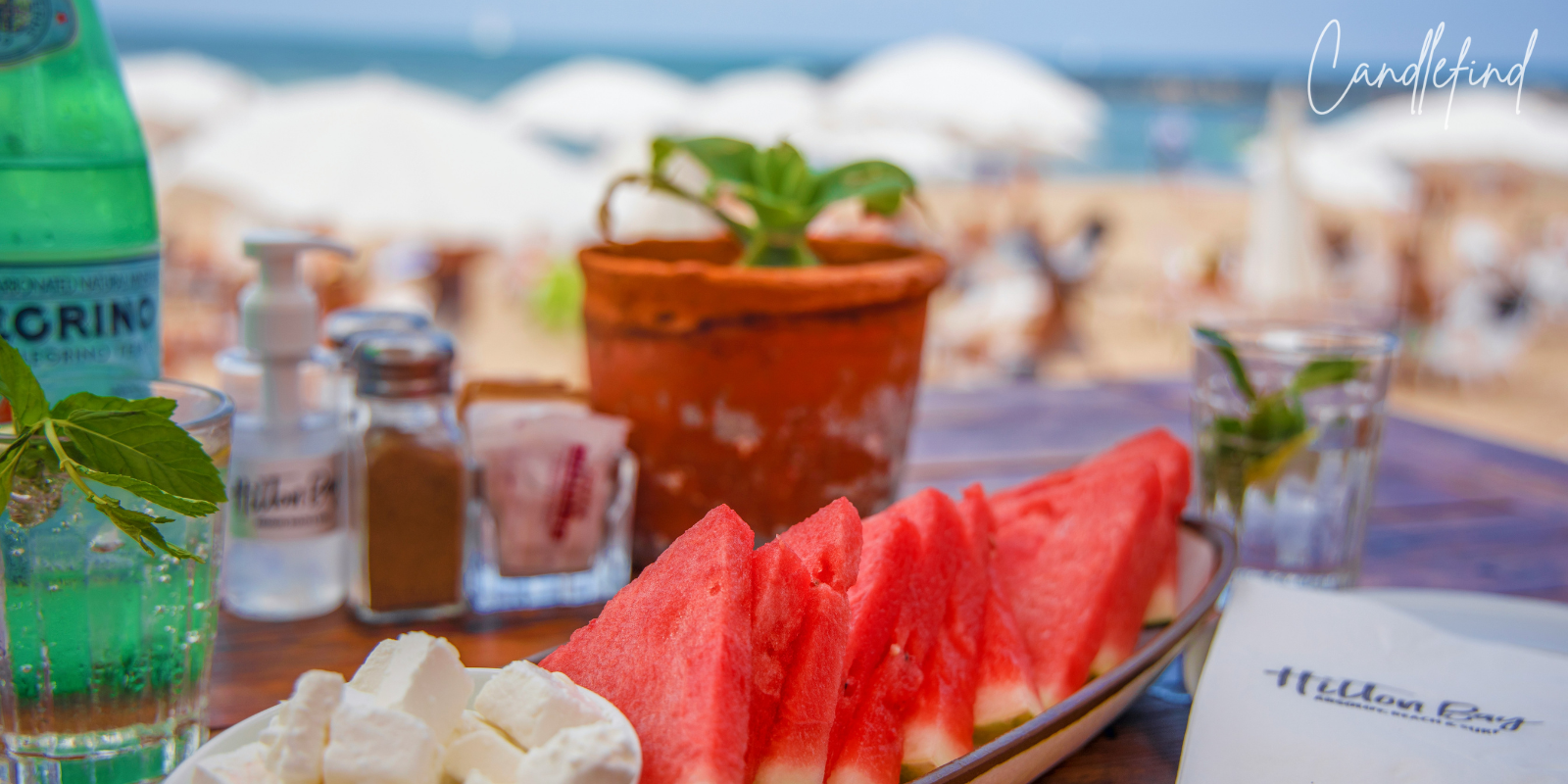 Fresh watermelon slices served at a beachside table overlooking the ocean